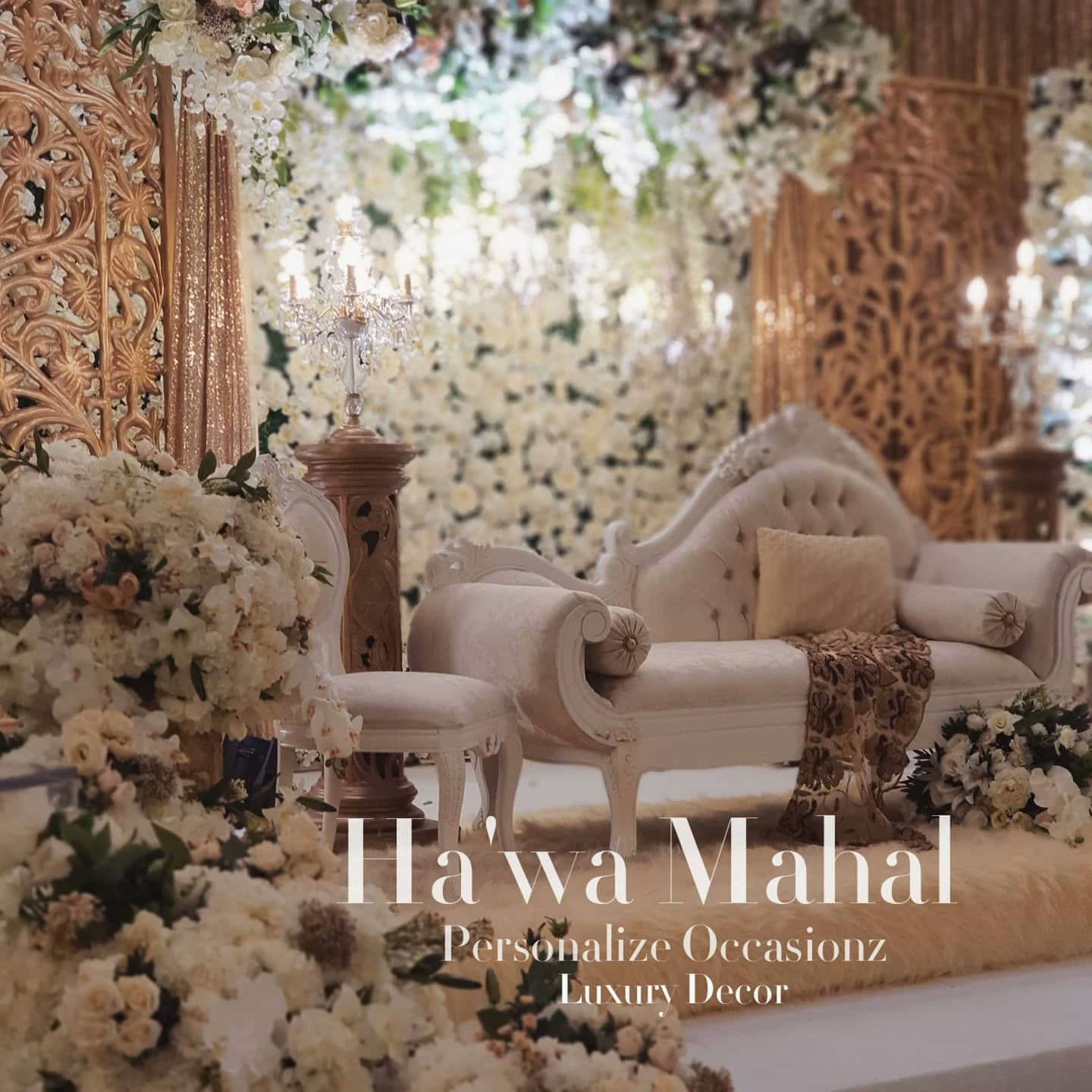 Carved gold panels and a wall of ivory flowers behind a white chaise in the Ha'wa Mahal collection.