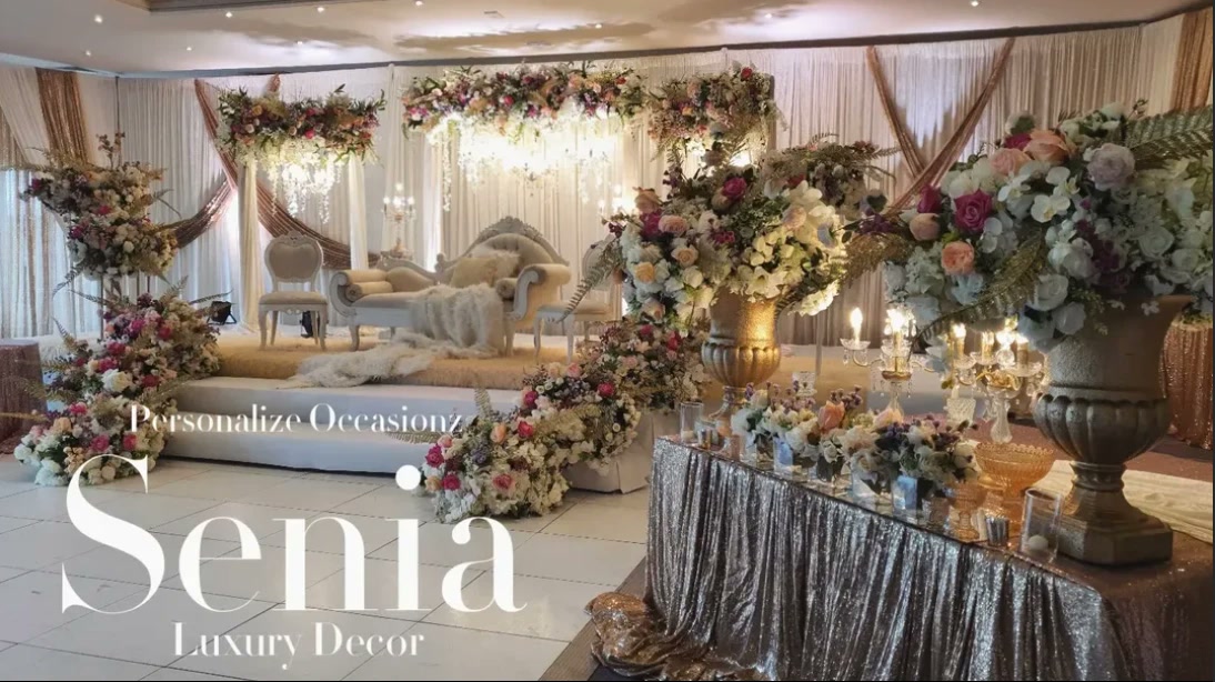 Pastel florals, gold urns and crystal candelabra around a stage in the Senia collection.