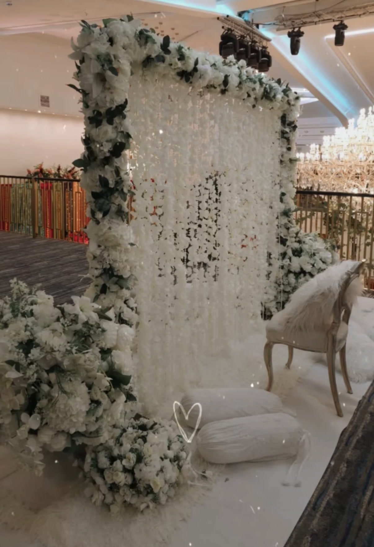 A nikkah partition covered in white flowers.