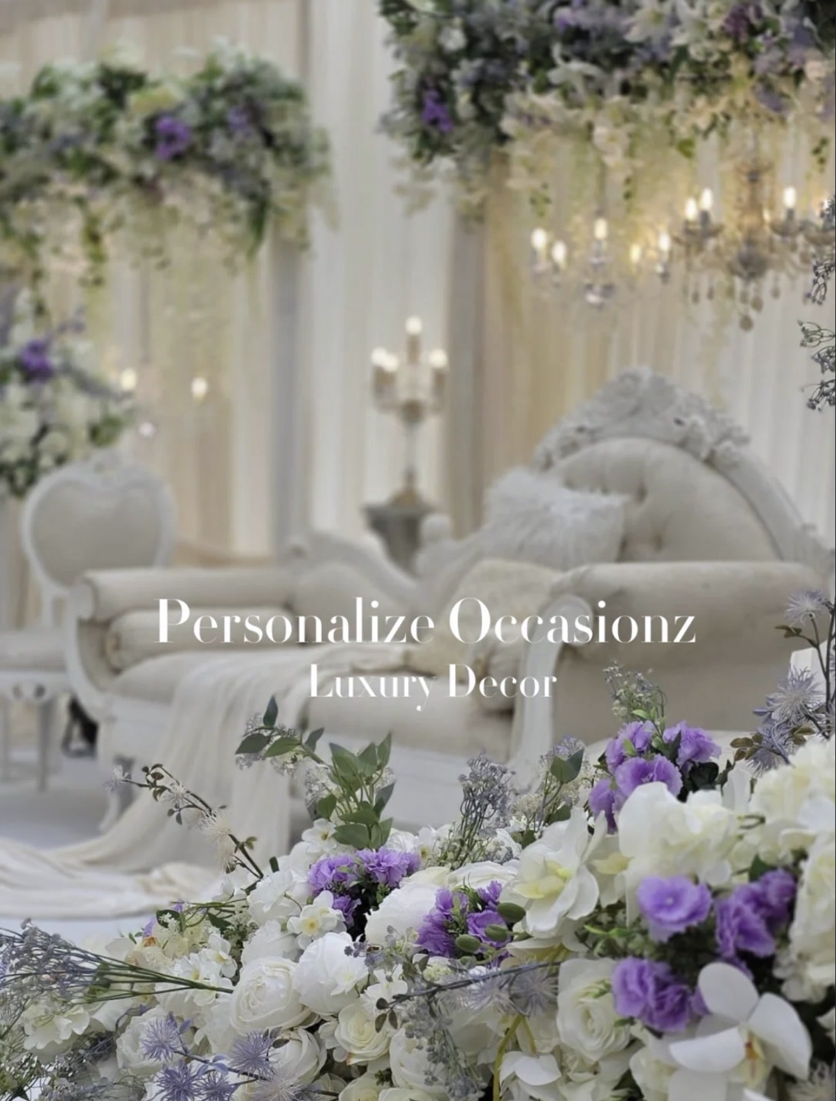 An ivory and lilac floral stage with a white carved sofa, styled by Personalize Occasionz.